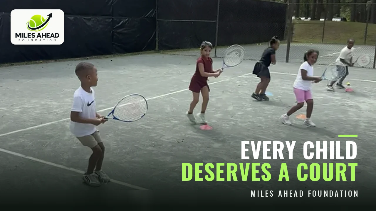 Young Miles Ahead Foundation players lined up practicing forehands on a tennis court