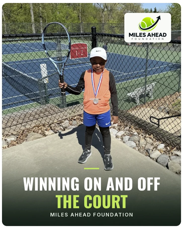 Young Miles Ahead Foundation player holding a medal and racket at the tennis courts